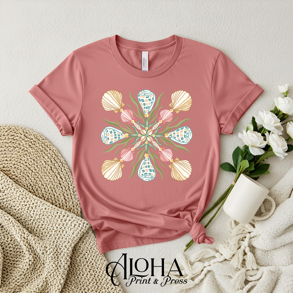 Mauve coastal Hebrew cone shell quilt design t-shirt with symmetrical beach mandala artwork