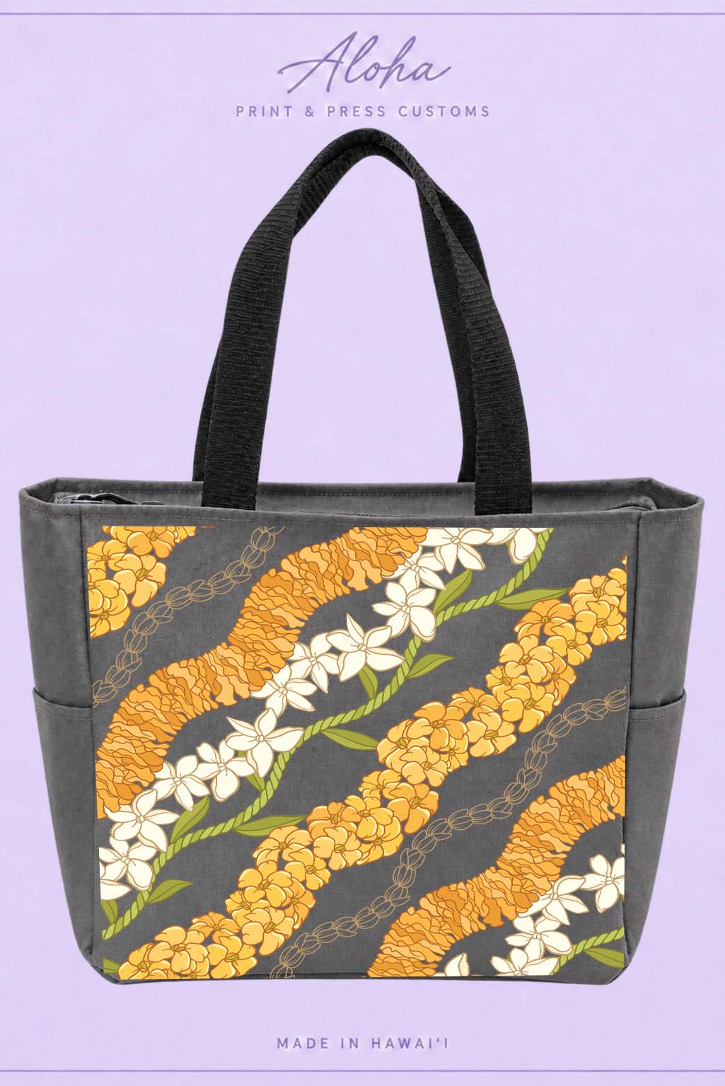 Dark charcoal lei tote bag featuring ʻilima, puakenikeni, maile, pikake, and tiare flowers