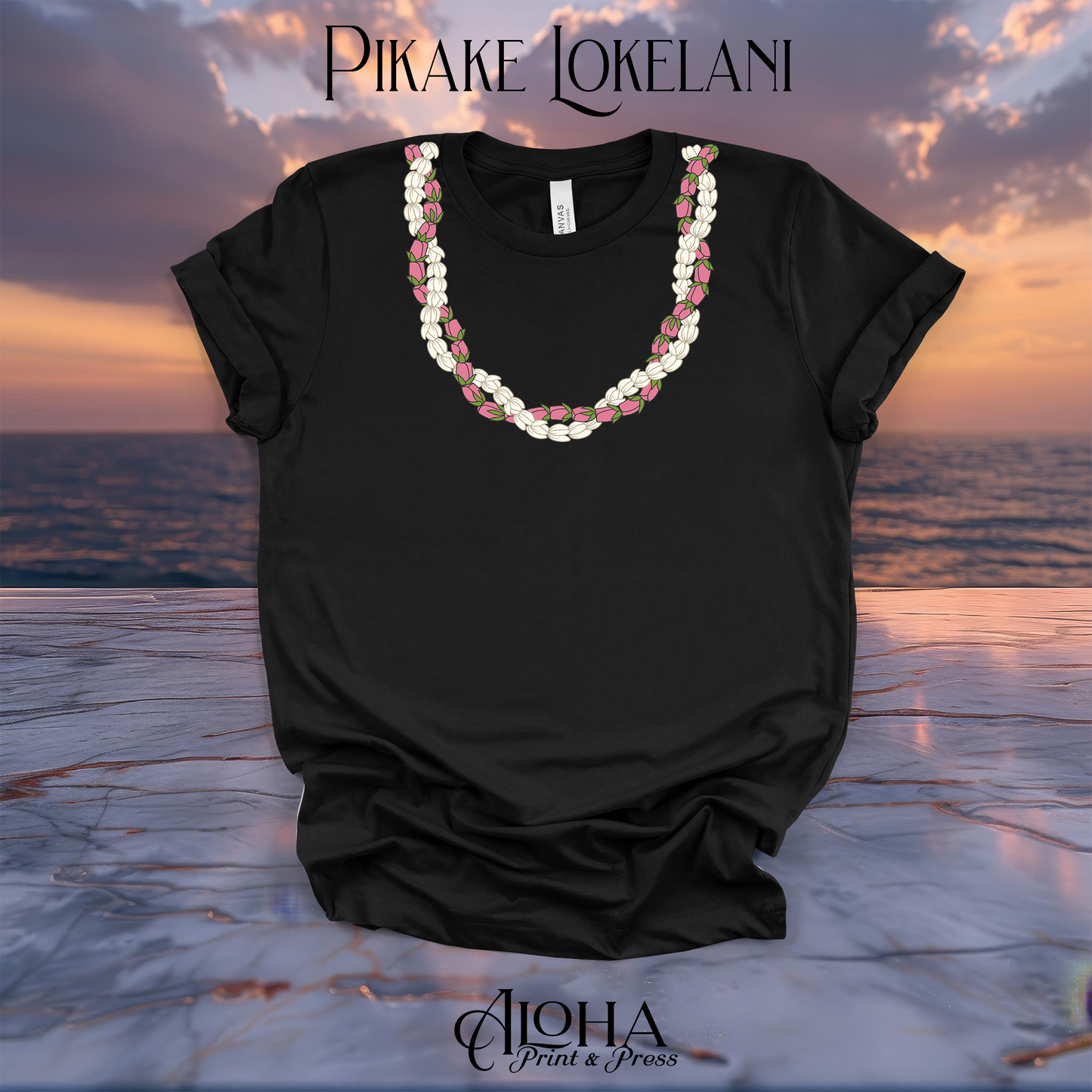 Black Bella Canvas 3001 graphic t shirt featuring a white Pikake and pink Lokelani Rose lei printed design by Aloha Print and Press