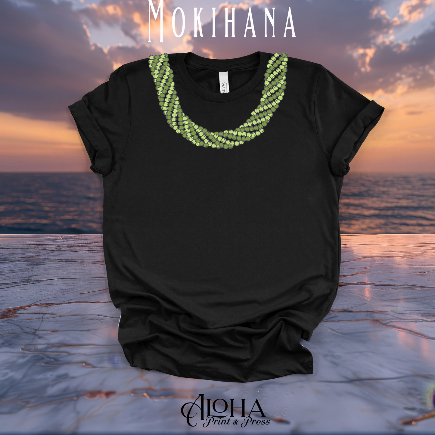Black Mokihana lei graphic T-shirt with a layered green Hawaiian lei neckline design against a sunset ocean background