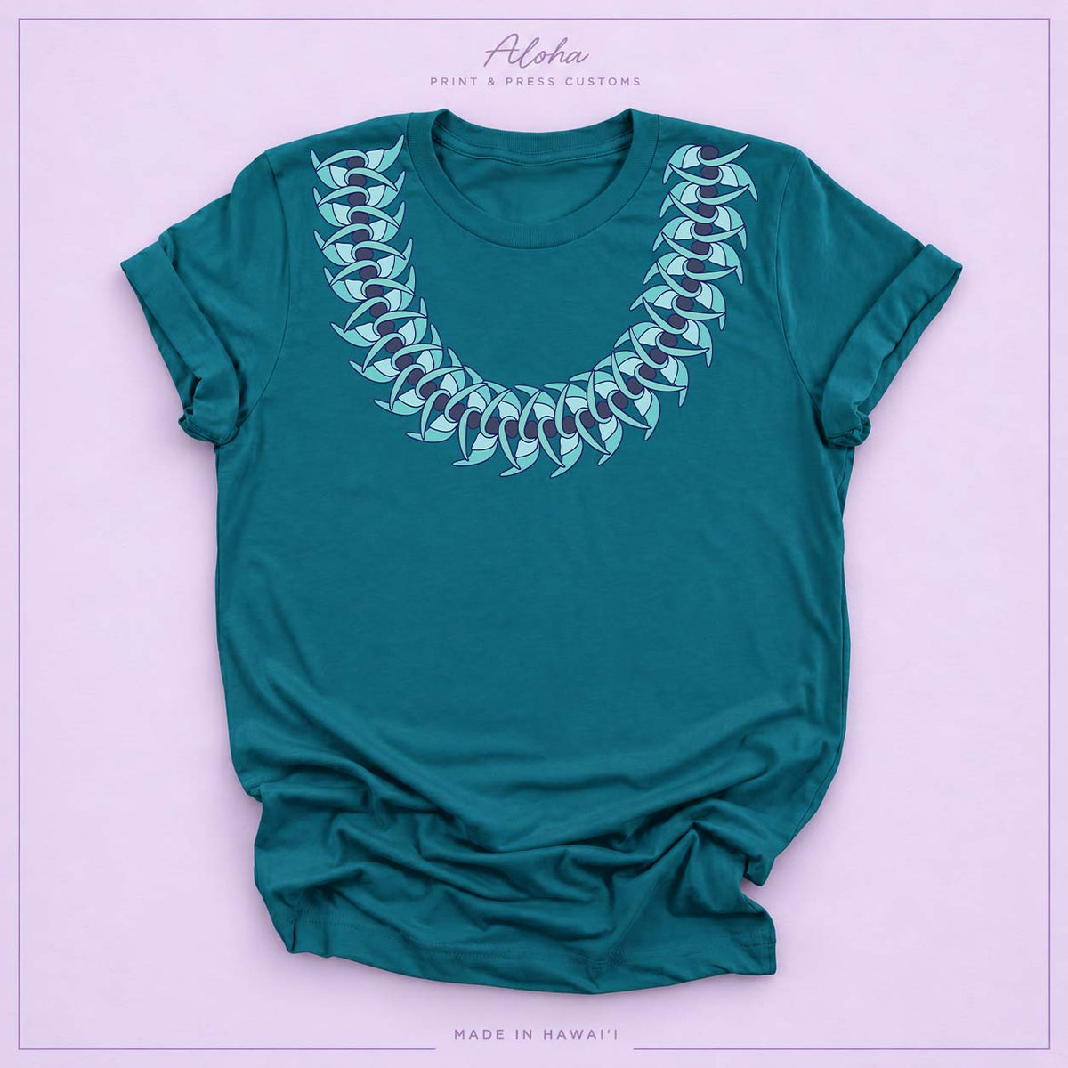 Deep teal T-shirt featuring a Blue Jade Hawaiian leaf lei design