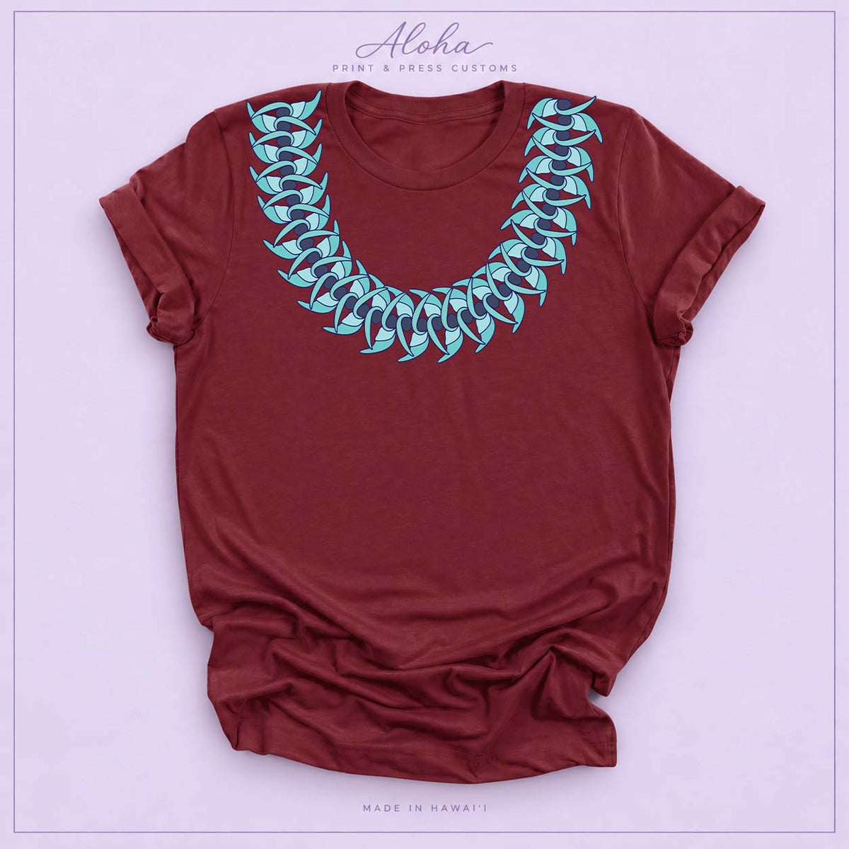 Maroon T-shirt featuring a Blue Jade Hawaiian leaf lei design