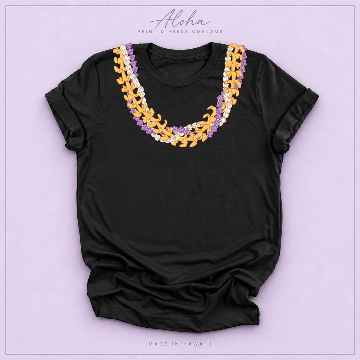 Black T-shirt with Crownflower, Pikake and Puakenikeni Hawaiian lei necklace design on Aloha Print & Press Customs branded background
