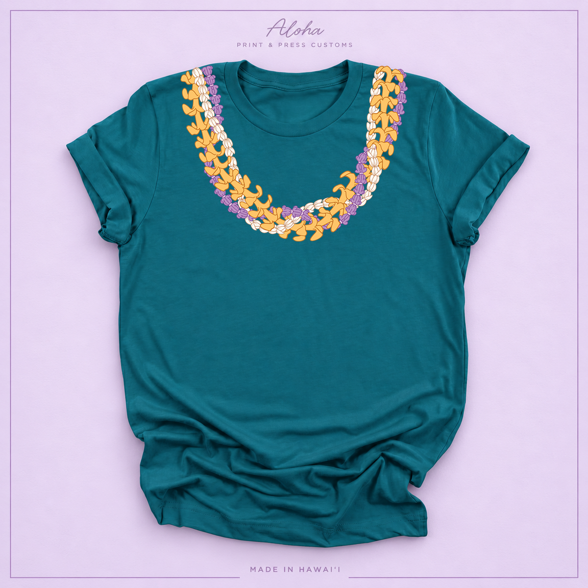 Deep teal T-shirt with Crownflower, Pikake and Puakenikeni Hawaiian lei necklace design on Aloha Print & Press Customs branded background