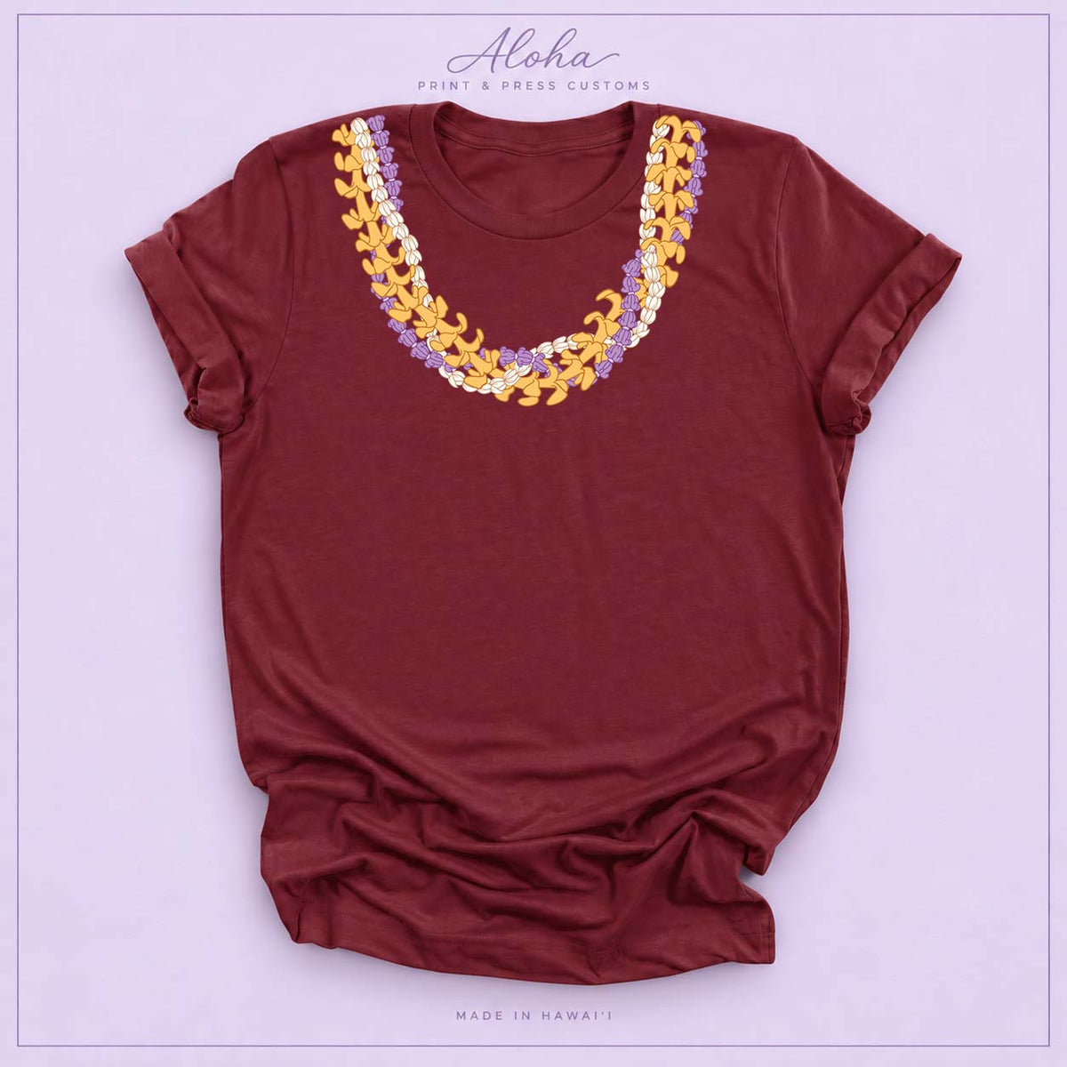 Maroon T-shirt with Crownflower, Pikake and Puakenikeni Hawaiian lei necklace design on Aloha Print & Press Customs branded background