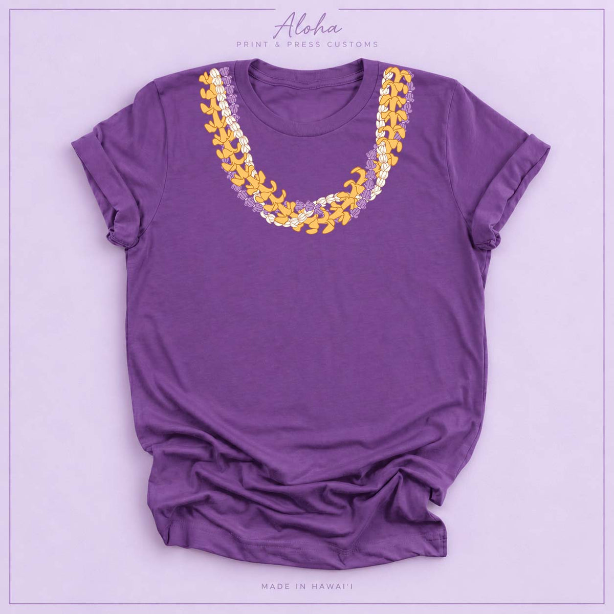 Purple T-shirt with Crownflower, Pikake and Puakenikeni Hawaiian lei necklace design on Aloha Print & Press Customs branded background