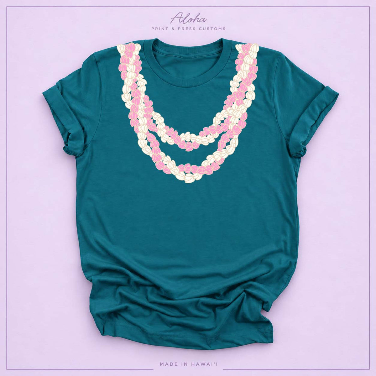 Deep teal T-shirt with pink and cream Double Pikake Lei design on Aloha Print & Press Customs branded background