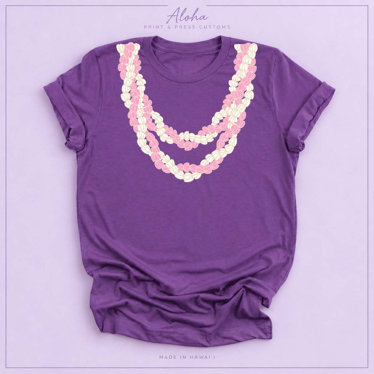 Royal purple T-shirt with pink and cream Double Pikake Lei design on Aloha Print & Press Customs branded background