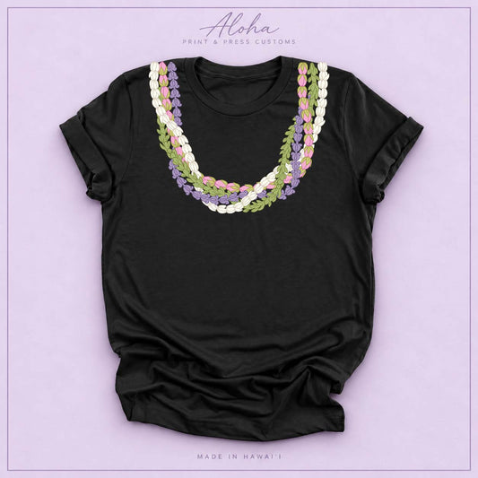 Black T-shirt featuring an island-inspired floral lei design on Aloha Print & Press Customs branded background