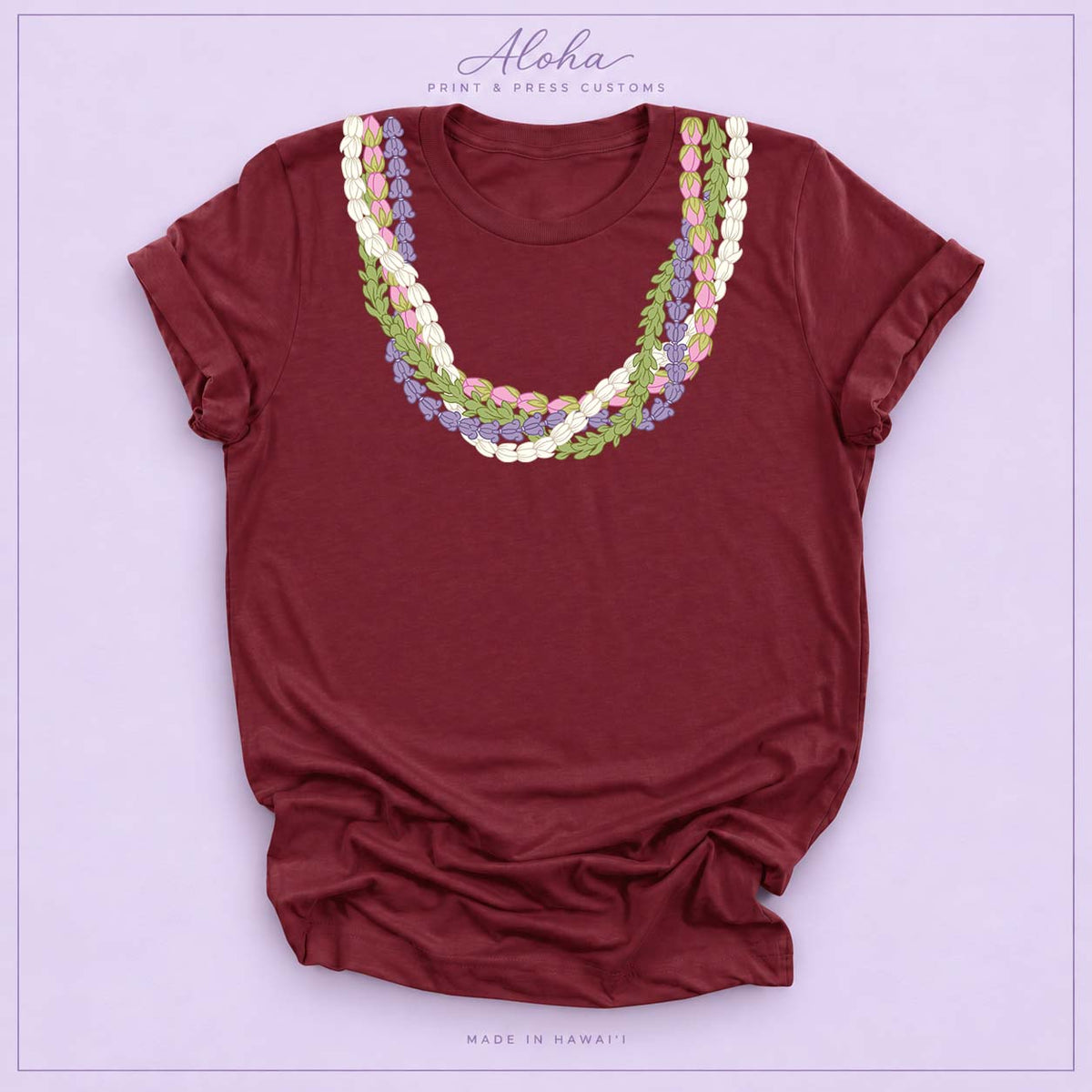 Maroon T-shirt featuring an island-inspired floral lei design on Aloha Print & Press Customs branded background