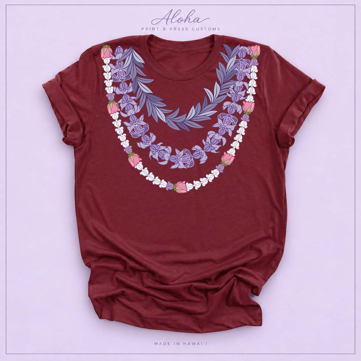 Maroon T-shirt featuring the Maile and Crownflower Triple Lei design