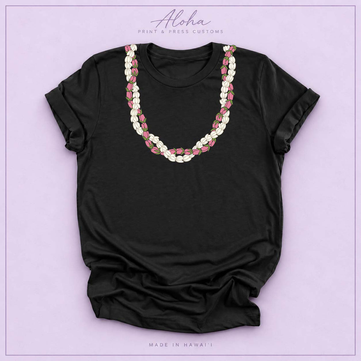 Black T-shirt featuring a Pikake and Lokelani lei design on Aloha Print & Press Customs branded background