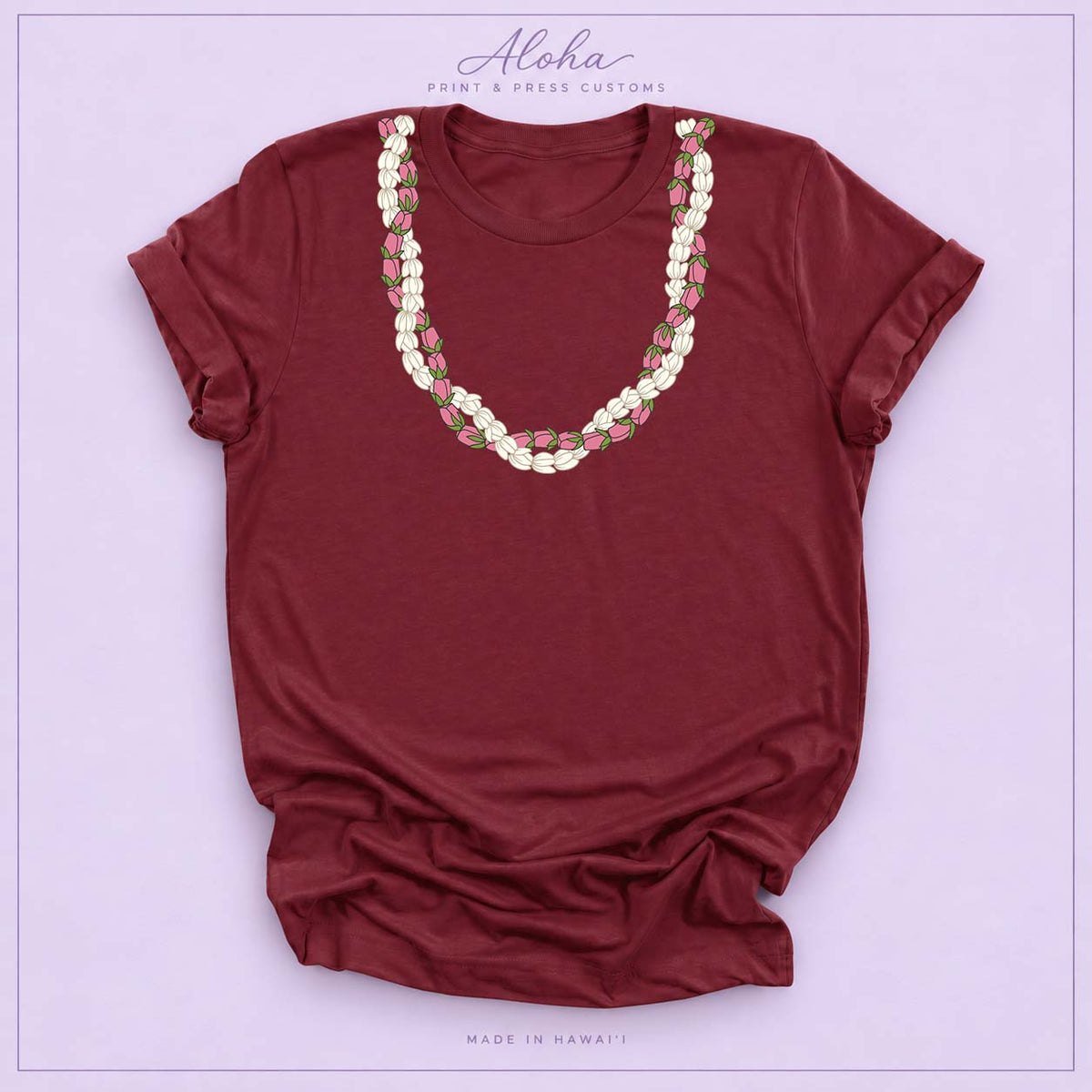 Maroon T-shirt featuring a Pikake and Lokelani lei design on Aloha Print & Press Customs branded background