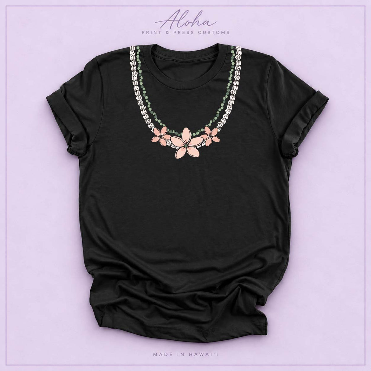 Black T-shirt with Pikake Mokihana Plumeria Hawaiian lei necklace design on Aloha Print & Press Customs branded background
